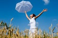 Happy young girl with umbrella in the field Royalty Free Stock Photo
