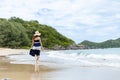 Happy young girl walking on the beach. Summer travel, vocation, holiday concept Royalty Free Stock Photo