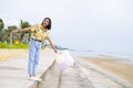 Happy young girl wear yellow shirt and hold balloon at beach Royalty Free Stock Photo