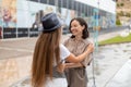 Happy young girlfriends meeting outside shopping mall Royalty Free Stock Photo