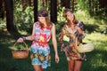 Happy young fashion girls walking in a forest