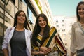 Happy young girls walking street after shopping. Royalty Free Stock Photo