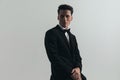 Happy young groom wearing black tuxedo and posing Royalty Free Stock Photo