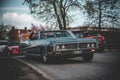 Happy young group driving old car in Nybro city Sweden during the Reggae event