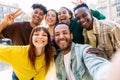 Happy young group of multiracial best friends having fun together outdoors Royalty Free Stock Photo