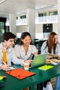 Happy young group of multiracial students working together on laptop at college Royalty Free Stock Photo