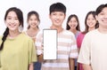 Happy young group teenager student  showing the smart phone with blank screen Royalty Free Stock Photo