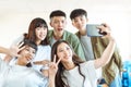 Happy young group of teenagers making fun selfie in classroom Royalty Free Stock Photo