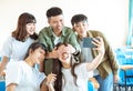 Happy young group of teenagers making fun selfie in classroom Royalty Free Stock Photo