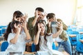 Happy young group of teenagers making fun selfie in classroom Royalty Free Stock Photo
