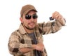 Happy young guy in flannel shirt and cap showing Royalty Free Stock Photo