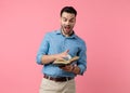 Happy young guy laughing and flipping pages Royalty Free Stock Photo