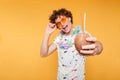 Happy young guy in sunglasses showing coconut cocktail Royalty Free Stock Photo