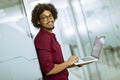 Happy young African American IT specialist wearing glasses working on his laptop in the office Royalty Free Stock Photo
