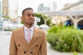 Happy young handsome African businessman thinking in the city outdoors Royalty Free Stock Photo