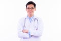 Happy young handsome Asian man doctor smiling with arms crossed Royalty Free Stock Photo