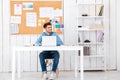 Happy young handsome businessman using laptop computer in office Royalty Free Stock Photo