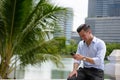 Happy young handsome businessman using phone at the park Royalty Free Stock Photo