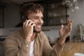 Happy young handsome man holding cellphone conversation. Royalty Free Stock Photo