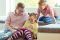 Happy young handsome father having fun with his two cute children playing with tablet Royalty Free Stock Photo