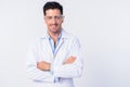 Happy young handsome man doctor wearing protective glasses with arms crossed Royalty Free Stock Photo