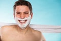 Happy young handsome man with shaving cream foam. Royalty Free Stock Photo