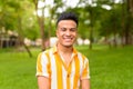 Happy young handsome multi ethnic man smiling at the park outdoors Royalty Free Stock Photo