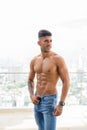 Happy young handsome muscular Persian man shirtless thinking against view the city Royalty Free Stock Photo