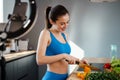 Happy young healthy woman influencer preparing fresh salad