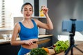 Happy young healthy woman influencer preparing fresh salad