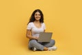 Happy young hindu lady typing on laptop keyboard Royalty Free Stock Photo