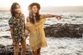 Happy young hippie couple having fun at the beach during sunset. Royalty Free Stock Photo