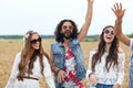 Happy young hippie friends dancing on cereal field Royalty Free Stock Photo