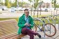Happy young hipster man with smartphone and bike Royalty Free Stock Photo