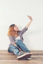 Happy young hipster woman taking selfie photo on smartphone over Royalty Free Stock Photo