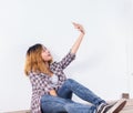 Happy young hipster woman taking selfie photo on smartphone over white background Royalty Free Stock Photo