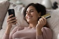 Happy Latin woman shopping online on cellphone Royalty Free Stock Photo