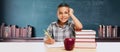 Happy Young Hispanic School Boy At Desk with Books and Apple In Front of Chalkboard Royalty Free Stock Photo