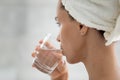 Happy young hispanic woman drinking glass of fresh water. Royalty Free Stock Photo