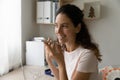 Happy young hispanic woman recording audio message on cellphone. Royalty Free Stock Photo