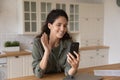 Happy young hispanic woman holding mobile video call conversation. Royalty Free Stock Photo