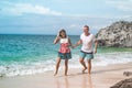 Happy young honeymoon couple having fun on the beach. Ocean, tropical vacation on Bali island, Indonesia. Royalty Free Stock Photo