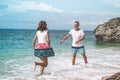 Happy young honeymoon couple having fun on the beach. Ocean, tropical vacation on Bali island, Indonesia. Royalty Free Stock Photo