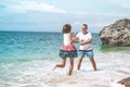 Happy young honeymoon couple having fun on the beach. Ocean, tropical vacation on Bali island, Indonesia. Royalty Free Stock Photo