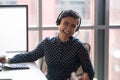 Happy young indian businesswoman call center agent laughing at workplace Royalty Free Stock Photo