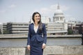 Happy young Indian businesswoman with St. Paul's Cathedral in background