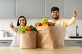 Happy young indian couple with paper bags full of grocery Royalty Free Stock Photo