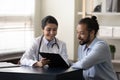 Happy young indian doctor discussing treatment with african patient. Royalty Free Stock Photo