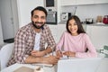 Happy young indian father helping teen daughter learning at home, portrait. Royalty Free Stock Photo