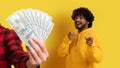 Happy young indian guy point fingers at camera near hand with many money Royalty Free Stock Photo